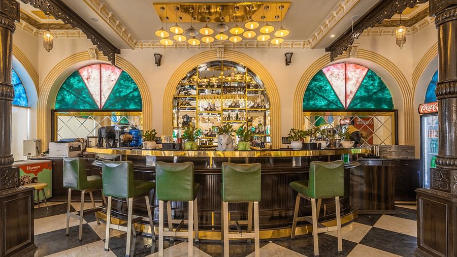 an image of the the bar counter with with glass windows in the wall and hanging lights